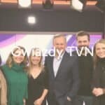 Group of popular Polish TV personalities from TVN, smiling and posing together, studio lighting, professional and glamorous, modern.